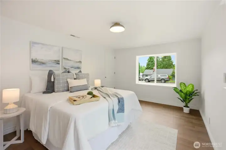 Years ago a previous owner likely converted the garage into a primary bedroom. It's recently been updated with engineered hardwood floors, new paint and new lighting fixtures.