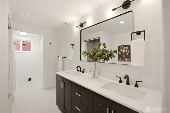 Just outside the primary bedroom is a well appointed 3/4 bath with dual vanities and an adjacent laundry room.