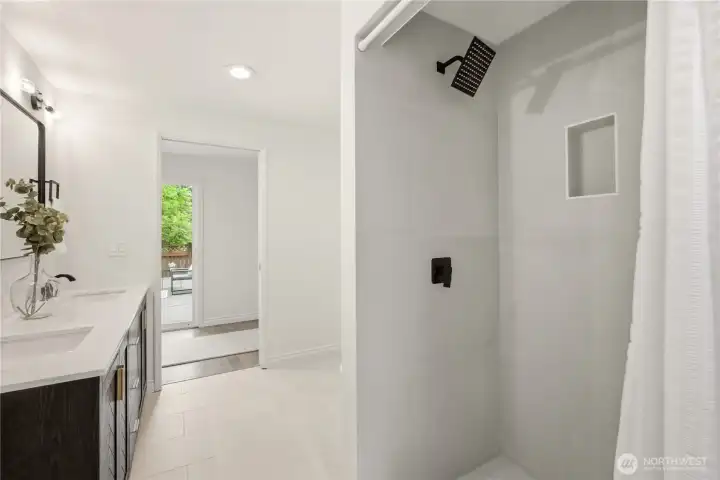 The tile shower stall was recently installed with lovely tile and a rainfall showerhead.