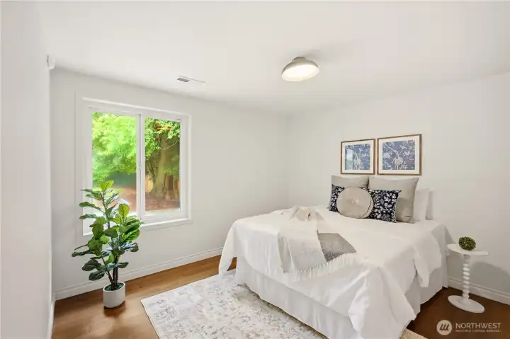Back towards the front of the house are the 2 original bedrooms, each with a good sized closet and recent upgrades including new light fixtures, new paint and new engineered hardwood flooring.