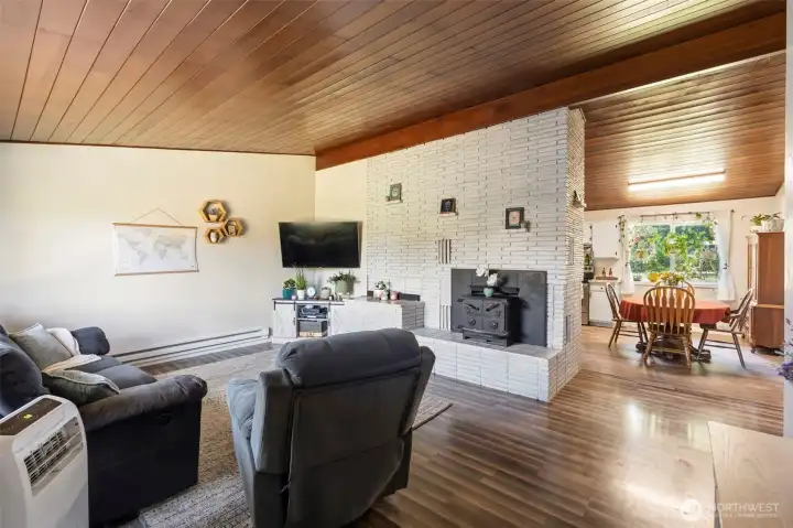 Step into an open concept space with wooden vaulted ceilings.