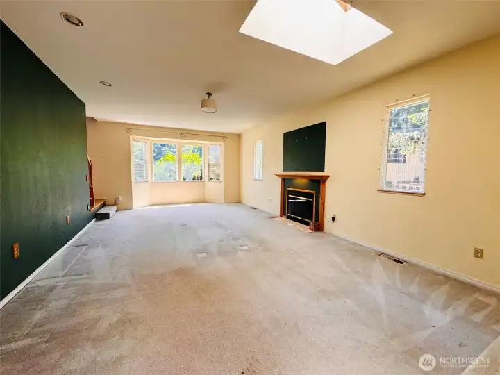 Spacious living room with lots of windows and skylight