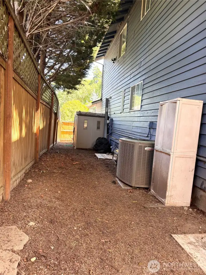 Side yard storage shed, A/C unit, generator hook up.
