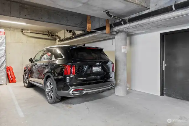 Your own parking space in the secured garage- and the entrance to the storage is the black door to the right