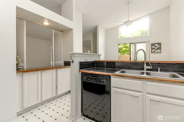 The kitchen has a wet bar which the plumbing is capped I'm the cabinet.  The wet bar opens to the living room and there are louvered doors