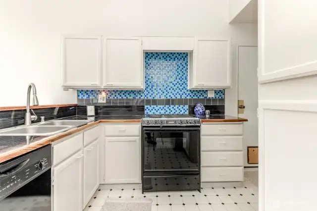 The kitchen has new counter tops and back splash.
