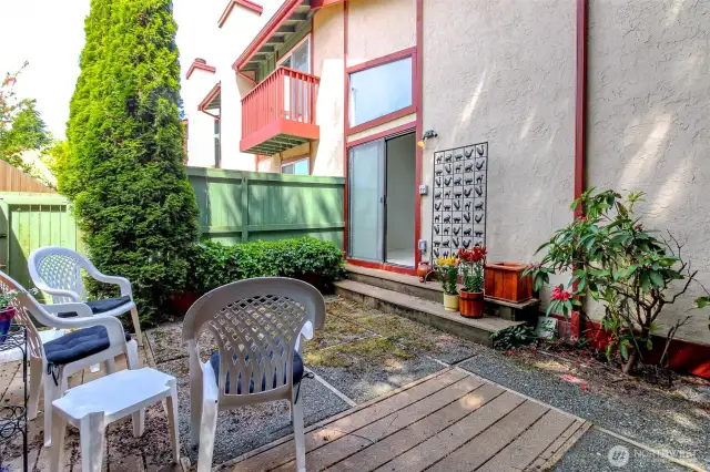 The patio can be accessed from the sliders off the dining room or you can follow the side yard pathway from the front door.