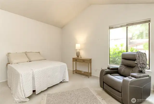 The primary bedroom has two corner windows, both that open and have screens.  Vaulted ceiling too.