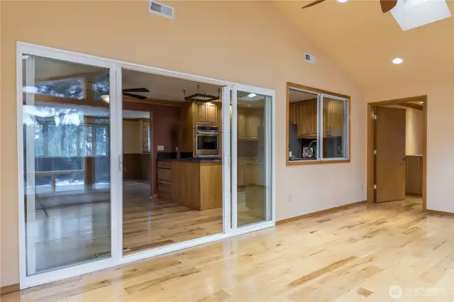 Family room off the kitchen has vaulted ceiling & skylights