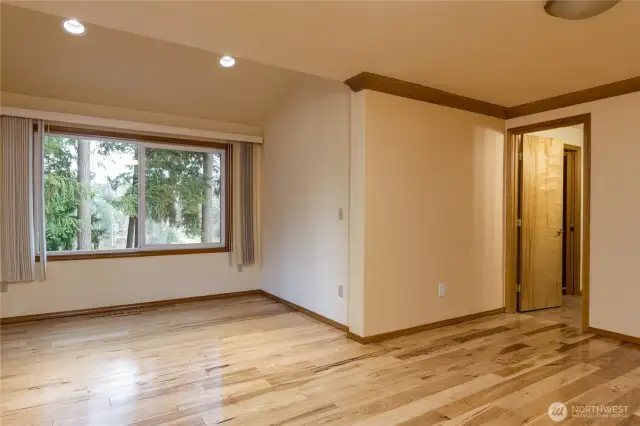 Spacious primary bedroom has extra sitting area where you can enjoy the lake view!