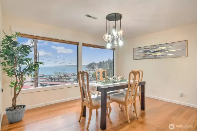 Dining room has wall of windows to capture the amazing views
