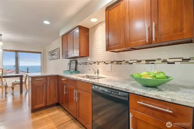 Custom cabinets, granite countertops and beautiful tile backshplash