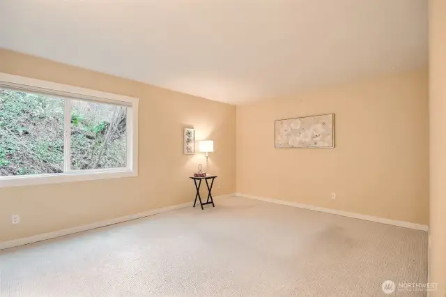 Huge Primary bedroom windows look out greenbelt like forest