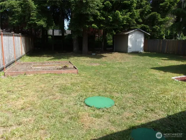 Flat back yard is perfect for many activities.
