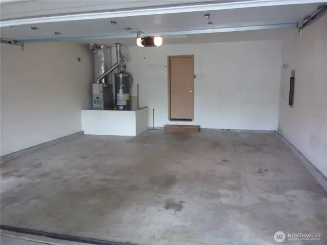 Fully sheet rocked garage with garage door opener.
