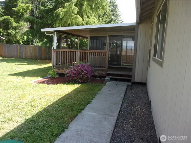 Sidewalk leads up the deck and into the sun room.