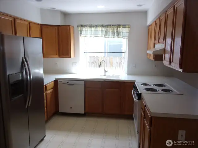U-shaped step saver kitchen with garden window over the double sink.