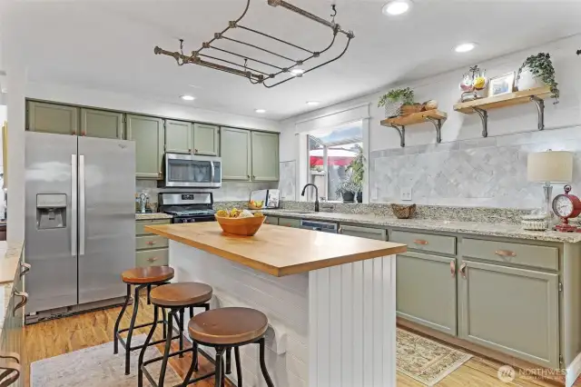 Gorgeous kitchen with custom color cabinets and Marble  walls