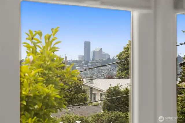 Peek views of downtown Seattle, lake, Seward Park & Mountains