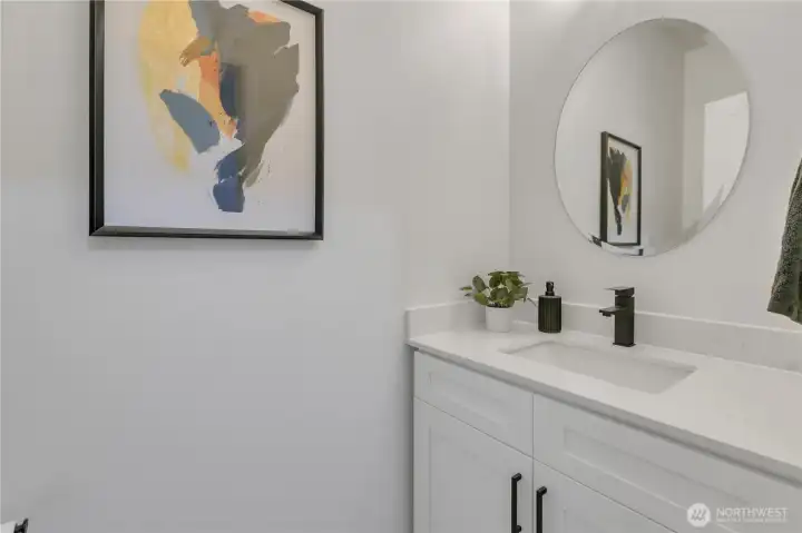 Fully renovated powder room with new sink, vanity and toilet