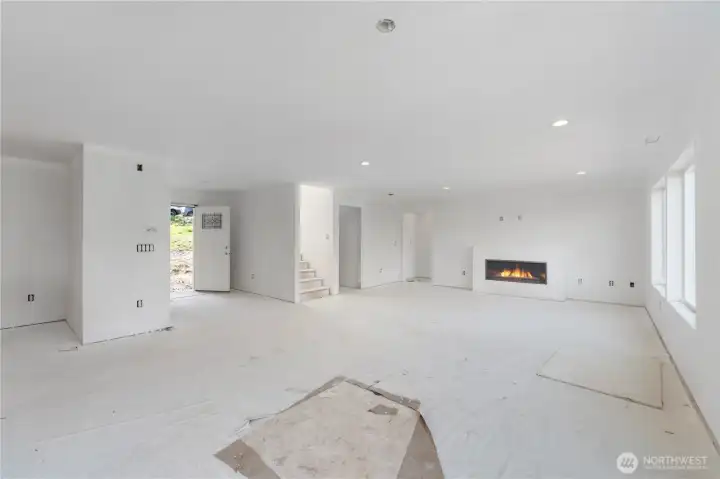Great room with electric fireplace.  LVP for all flooring on the main floor.