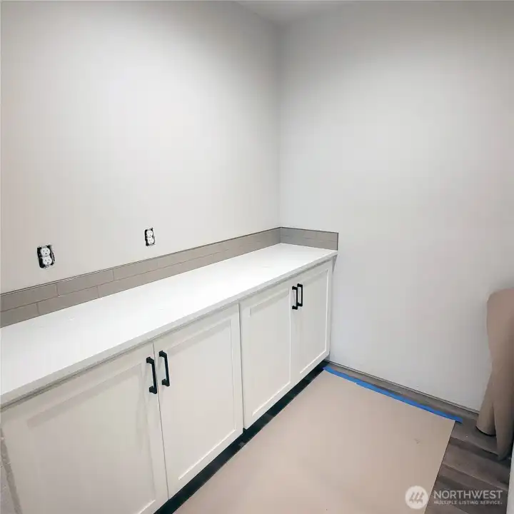 Large walk in pantry with cabinets, dedicated electrical line & back splash.