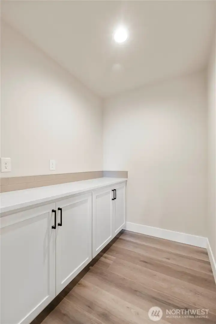 Large pantry with countertop space for the microwave.