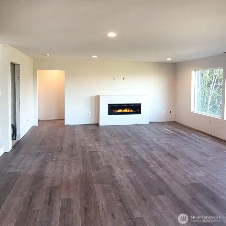 LVP flooring, electric fireplace and tons of natural light