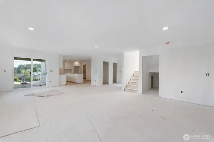 Nice shot of the family room, dining space & kitchen.  Coat closet & half bath too.  Loads of storage under the stairwell.