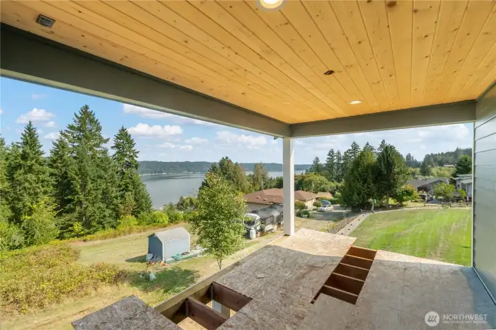 Covered porch will have trex surface & black railing. Wired for future ceiling fan as well!
