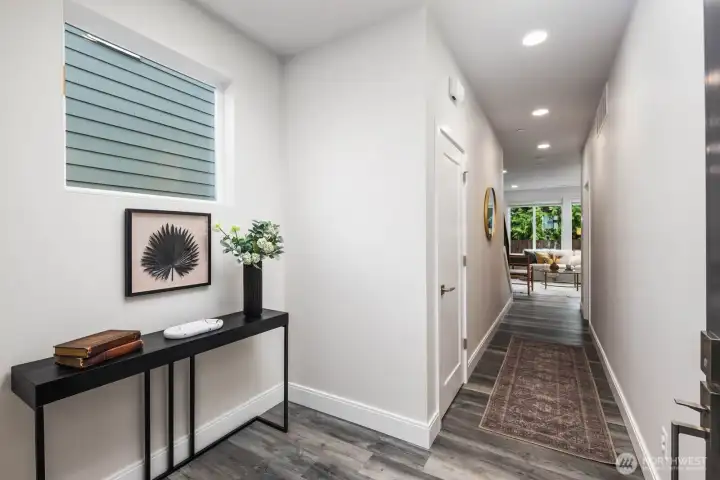 Entryway with coat closet and room for a bench.