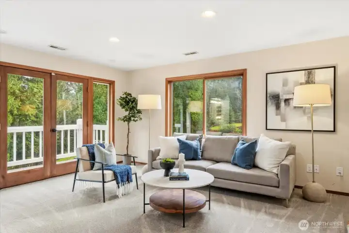Sitting area and private balcony off of primary bedroom