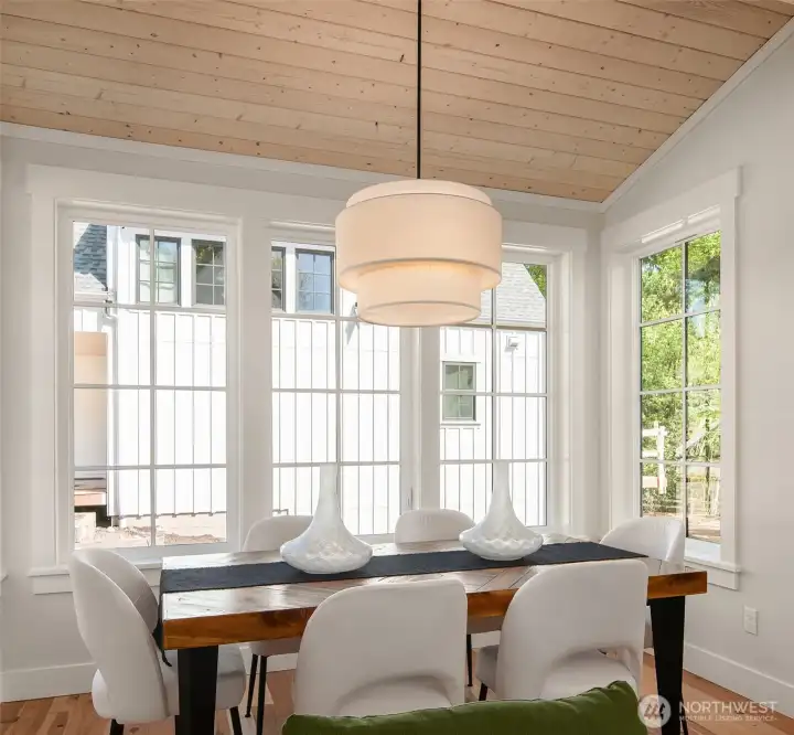 A cozy spot with lots of room for dinner with family and friends, overlooking the fenced rear yard and lush open spaces.