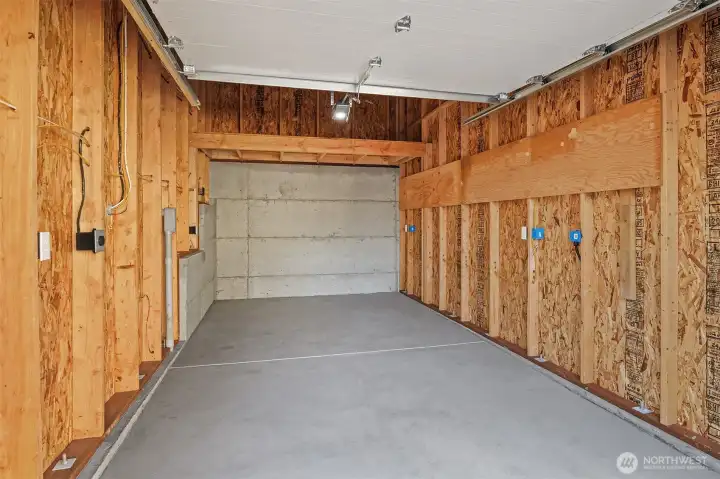 The large, secure, detached garage space is fitted with loft storage and a dedicated circuit EV charger.  Plenty of room for a normal car and still have room for a workbench and storage.
