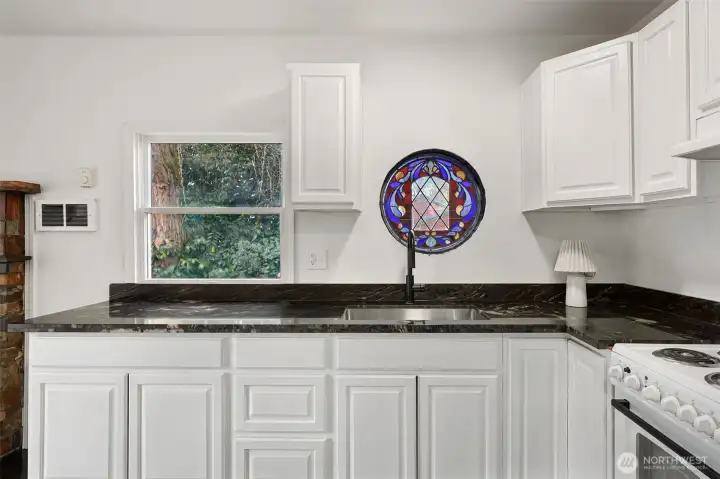 Look at this adorable window above the kitchen sink.