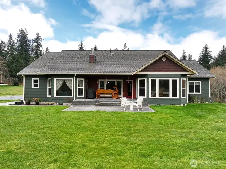 Back side of home with exposed aggregate patio.