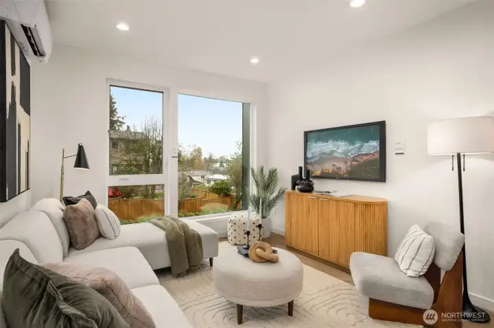 Relax in a sophisticated living space featuring designer lighting, sleek hard-surface flooring, and a layout perfectly suited for both quiet nights and lively entertaining