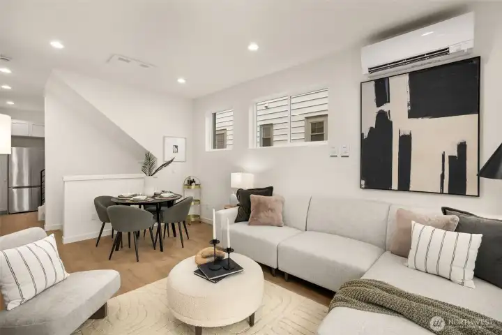 A chef’s dream kitchen awaits, boasting custom cabinetry, premium stainless steel appliances, and elegant quartz countertops with a waterfall edge