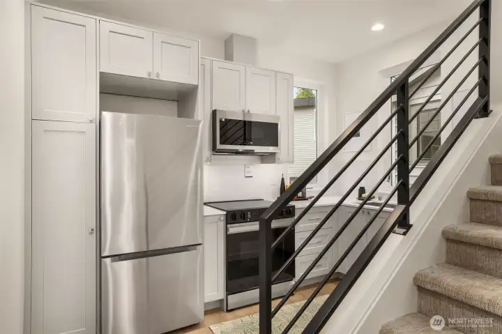 Architectural metal railings and oversized windows turn every transition between floors into a bright, modern experience