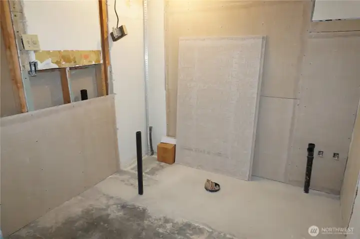 Unfinished full bath that has been plumbed. Also a large soaking tub in the living room goes in this bathroom.