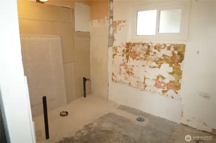 Newer windows, plumbing in and unfinished add you finishing touches. Large tub is included.