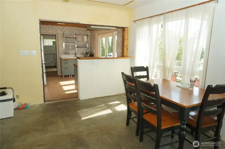 Dining area with a large window and sliding windows for cool breezes and fresh air.