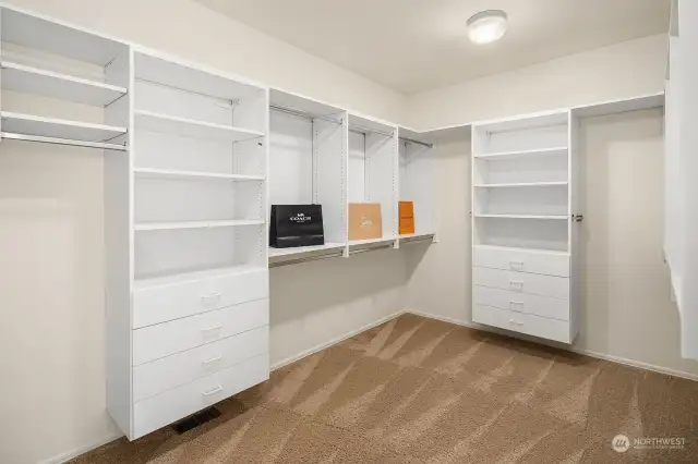 Primary Suite walk-in closet with closet organizer.