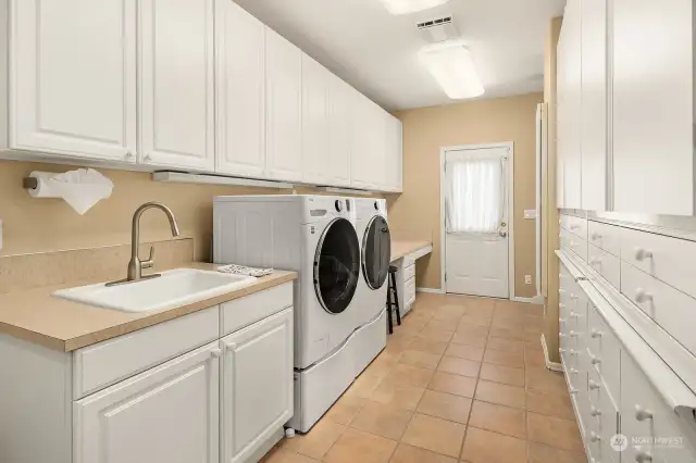 Expansive laundry room with ample built-in cabinets & another bathroom adjacent to the garage. All appliances included.