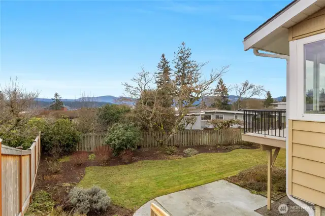 Level, fenced back yard with both patio and deck.