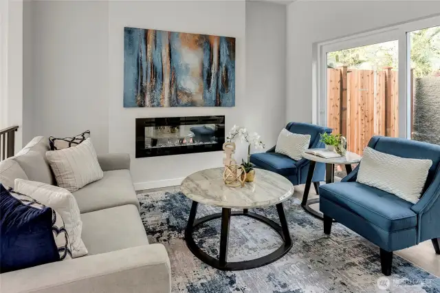 Two tiered dining and living space with electric fireplace (model home lot 24)