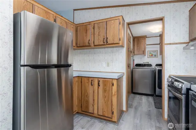 The kitchen offers updated fridge with additional counter space and storage