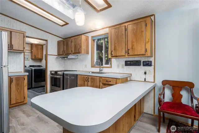 This bright, functional kitchen features updated appliances, ample cabinetry, and a large countertops that are perfect for meal prep or casual dining.