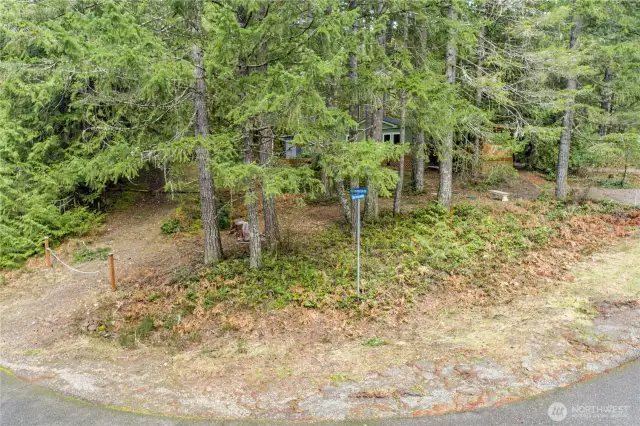 this private wooded lot offers a peaceful retreat just moments from Lake Cushman’s amenities. Natural landscaping and mature evergreens surround the property, creating a serene setting ideal for nature lovers.