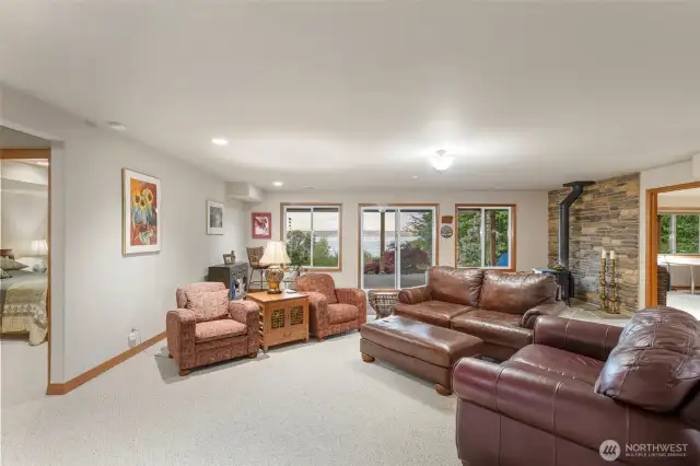 Lower level Den with access to lower deck featuring a wood fired stove and a great view.